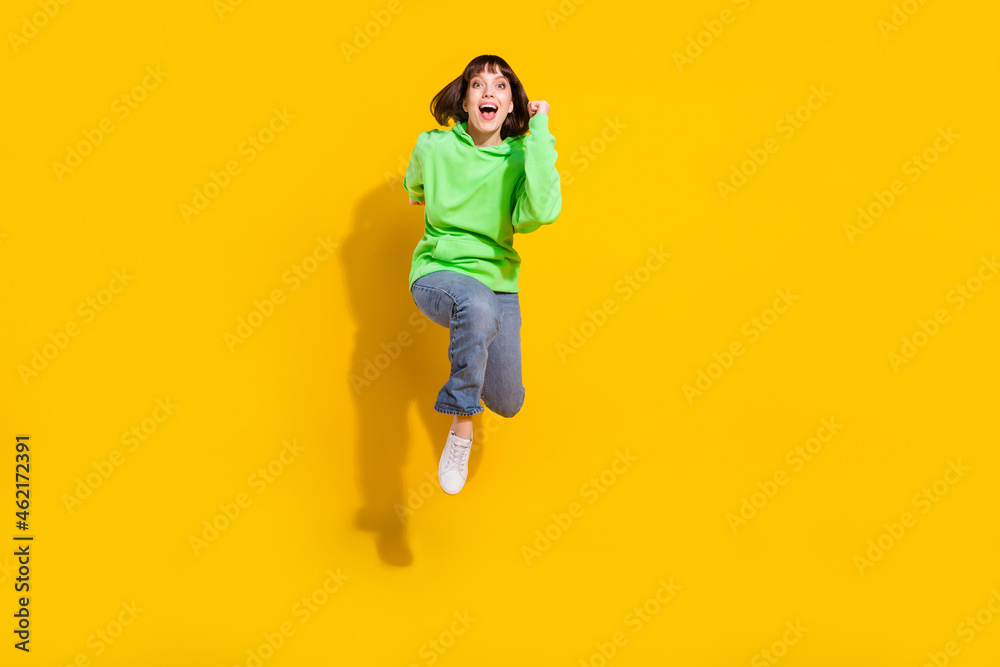 Sticker Full length body size view of attractive cheerful girl jumping running marathon isolated over bright yellow color background