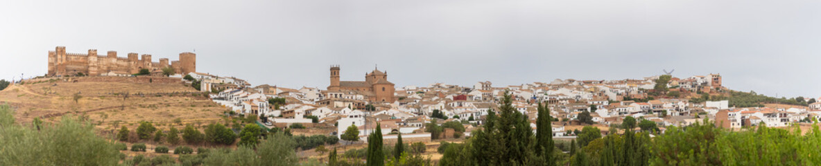 Fototapeta na wymiar Amazing ultra panoramic view at the Baños de la Encina village, medieval Castle and San Mateo church