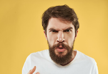 Obraz premium bearded man in a white t-shirt hand gestures anger Studio