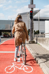 city transport and people concept - woman with bicycle waiting for green traffic light signal on...