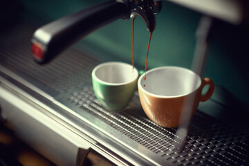 Close up of a cups filling with organic coffee