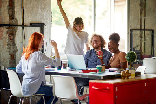 Group of young colleagues are working in a pleasant atmosphere in the office together