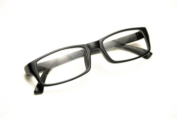 Reading glasses with black frames on a white background