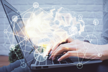 Multi exposure of woman hands working on computer and brain hologram drawing. Ai concept.