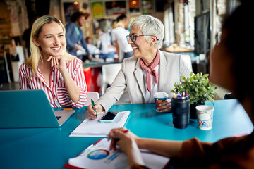 Senior female colleague mentoring young employees