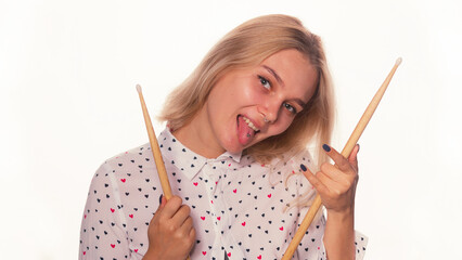 Rock and roll music concept. Young woman face with piercing shows her tongue and and holds...