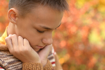 Portrait of a sad little boy outdoors