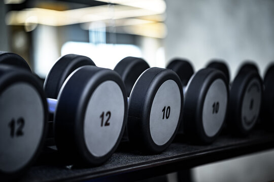 Close up of new dumbbells on a rack in a gym