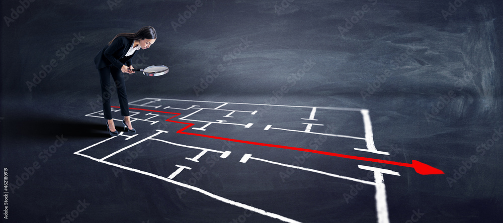 Poster attractive young businesswoman with magnifier looking at maze and arrow sketch on chalkboard backgro