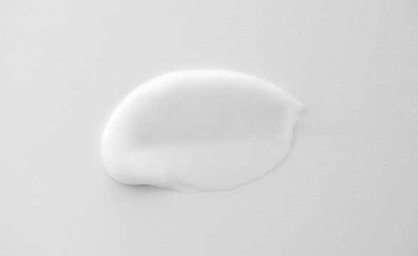 Soothe Cream Lotion Moisturiser Smear On Rough White Background, Vertical. Skincare And Body Beauty Product. Shampoo Or Hair Conditioner Smudge