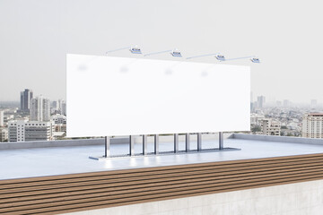 Obraz premium Empty white billboard banner on rooftop with city in daylight in the background. Outdoor advertisement and mock up concept. 3D Rendering.
