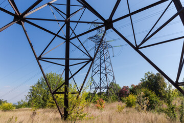 View of lattice transmission tower through the framework of another