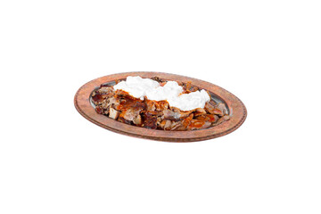 Traditional turkish iskender kebab in copper plate with yogurt. iskender on white background.