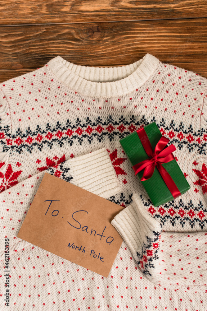 Canvas Prints top view of letter to santa near gift box on knitted sweater