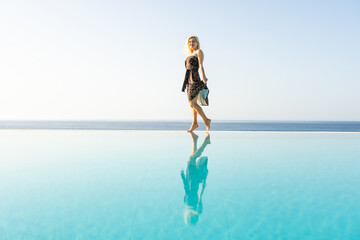 woman relaxing near swimming pool