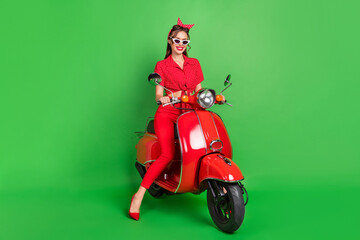 Fototapeta na wymiar Photo of stunning cute carefree lady drive moped wear sunglass dotted blouse high-heels isolated green color background