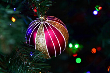  Christmas ball toy lies on shiny beads. Preparing for New Year, decorating house and the Christmas...