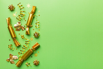 Christmas crackers with shiny confetti on color background, top view, copy space