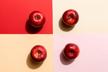 Many red apples on colored background, top view. Autumn pattern with fresh apple above view