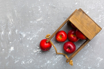 Many red apples on cement background, top view. Autumn pattern with fresh apple above view