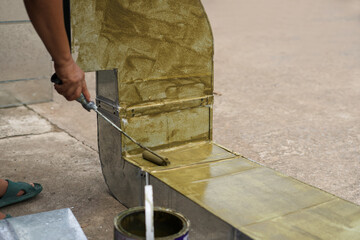 Workers are painting primer for air duct work.
