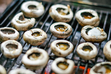 Cooking mushrooms at bonfire in campsite