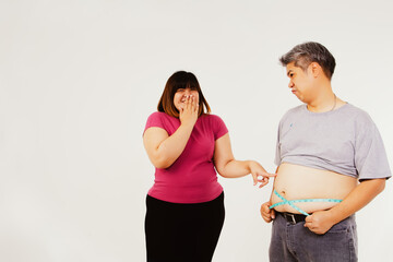 The obesity of a couple teases their bodies, jokes and laughs together : Man uses Tape measure to...