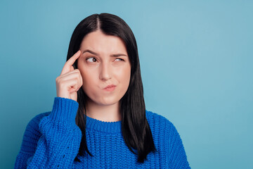 Photo of young girl look empty space think minded deep forget memory isolated on blue color...