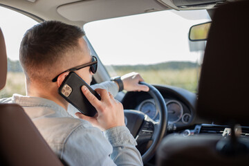 Businessman talking on cell phone while driving and overtaking, transportation and vehicle concept .