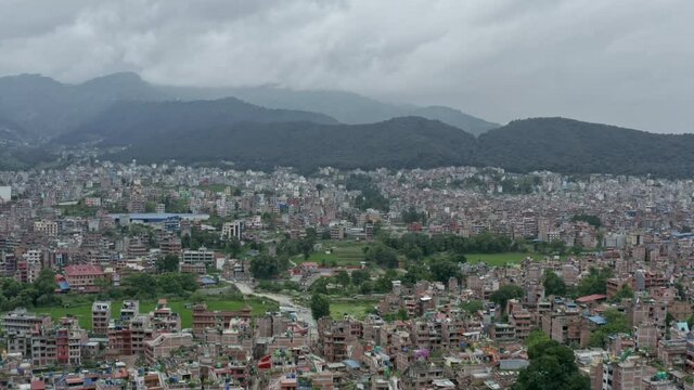 Aerial view Bhaktapur Nepal. The city in the Himalayas, houses and streets stand near agricultural fields in a landscape bridge with mountains.