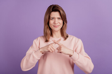 Photo of negative lady cross fingers show stop ban sign wear casual shirt on violet background