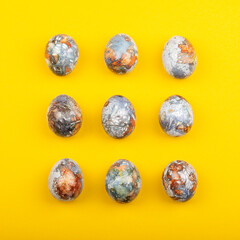 Colorful easter eggs painted in natural products blueberries and onion peels, isolated on yellow background