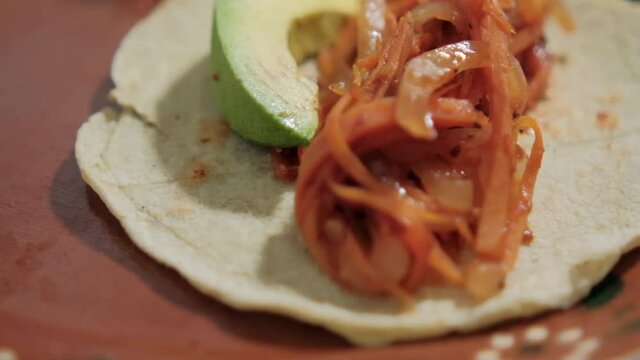 Vegan Mexican tinga taco on traditional clay plate