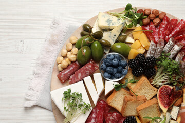 Different tasty appetizers on white wooden table, top view