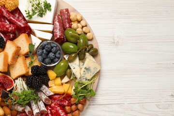Different tasty appetizers on white wooden table, top view. Space for text