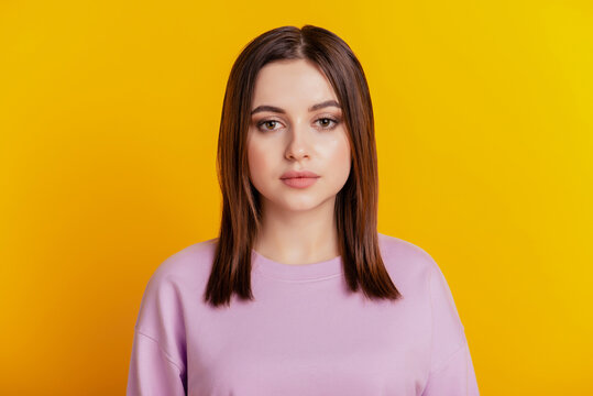 Photo of young attractive business woman serious confident calm isolated over yellow color background