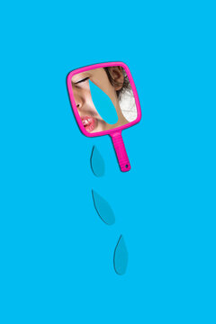 Reflection of girl on hand mirror with teardrops over blue background