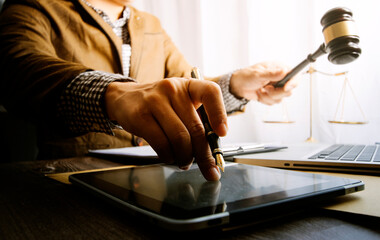 Male lawyer working with contract papers and wooden gavel on tabel in courtroom. justice and law ,attorney, court judge, concept.
