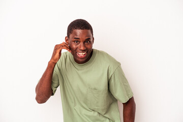 Young African American man isolated on white background laughing about something, covering mouth with hands.