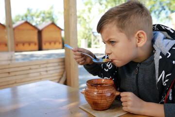 Hungry kid eating pot roast