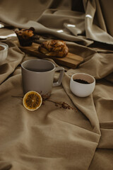 Background with a varied Mediterranean breakfast of coffee, coffee beans and ground with croissant and cupcake. Space for copying.