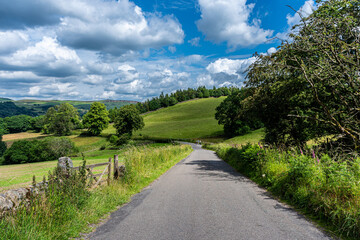 Fototapeta na wymiar road in the countryside with blue skies and clouds