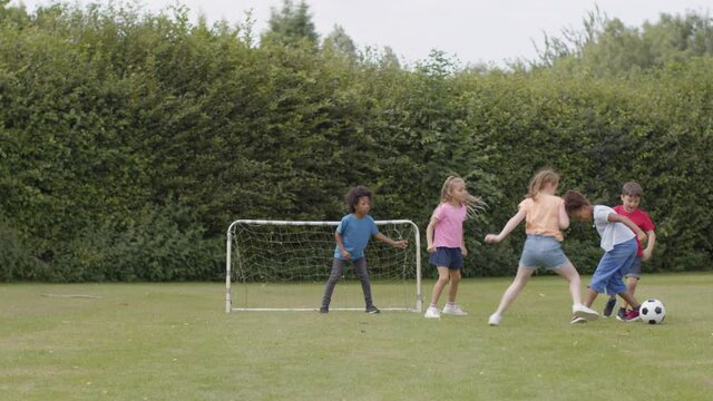 Tracking Shot of Group of Children Playing Football 09