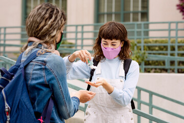 Students wearing mask at school, and using alcohol gel in the new normal