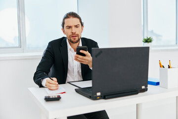 Man at the desk documents communication by phone Lifestyle