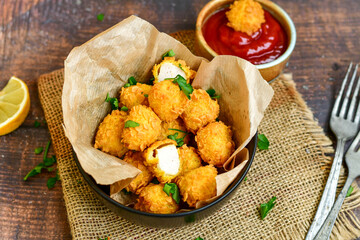 
 Crispy  deep fried   chicken   popcorns  Breaded  with cornflakes chicken  breast fillets  with chilly peppers and fresh   basil on wooden rustic background