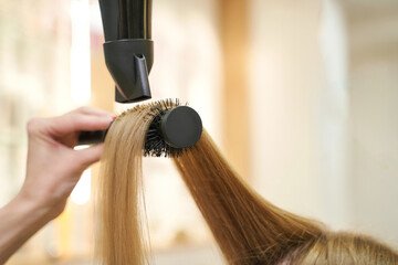 Repair long hair procedure. Haircut at salon. Woman hairstyle. Master hand with brush and fan....