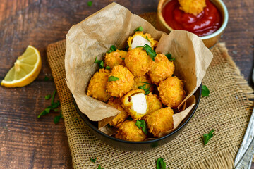  Home made Crispy Chicken   Popcorn   nuggets with  tomato ketchup sauce on wooden background