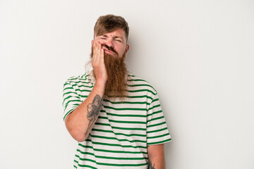 Young caucasian ginger man with long beard isolated on white background who feels sad and pensive, looking at copy space.