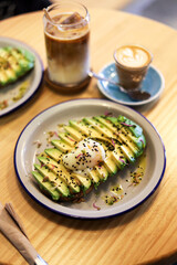 breakfast of avocado toast with egg and coffee with milk